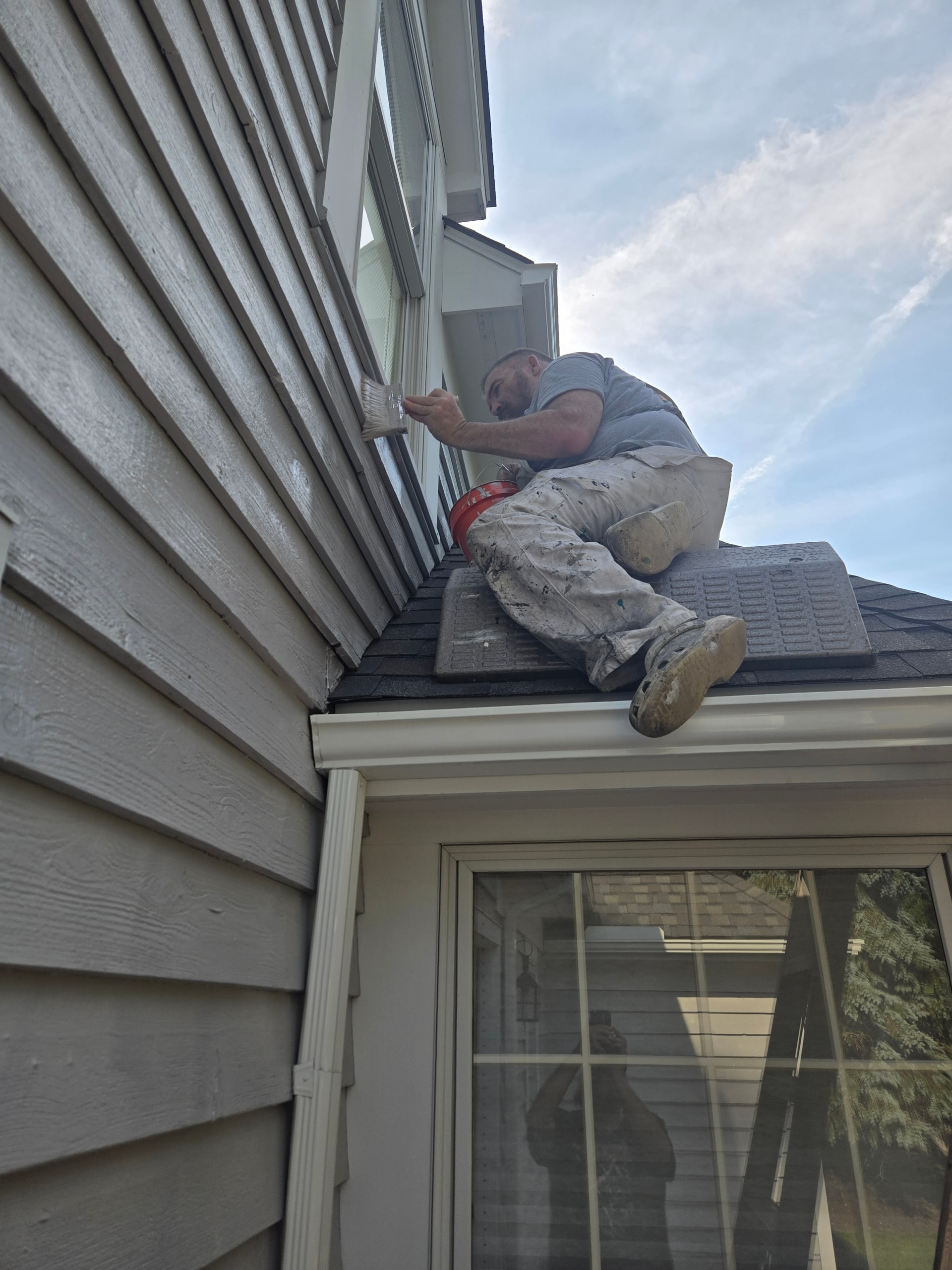 Jay, owner of Youngstown Painters, painting the exterior of a home in Youngstown Ohio